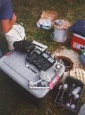 Sampling set up showing meters for dissolved oxygen, pH, redox, and electrical conductivity, bottle capper and other supplies.