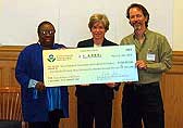 Photo of Deborah Jordan, EPA, giving CARE grant check to WOEIP.