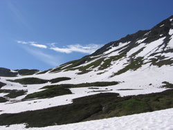 Mountainside with sparse snow