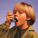 Boy using asthma inhaler