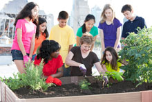 kids tending garden bed