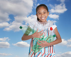 girl smiling holding recyclable bottles