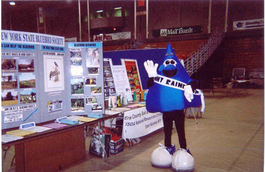 photo: Erie County SWCD mascot, Ronny the Raindrop, poses in front of several displays at the Earth Day Expo 2002