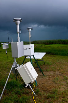 photo of air monitoring equiment in front of a stormy sky