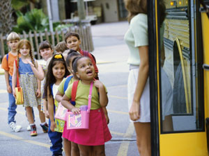 Children waiting to get on a school bus
