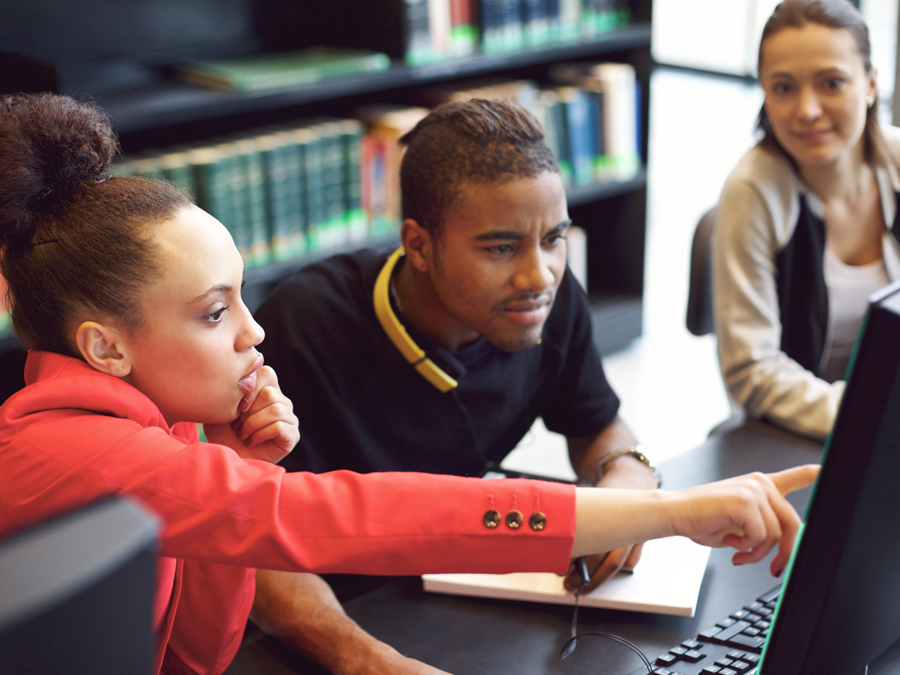 A group of people looking at a computer screen together