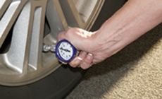 photo of man checking tire pressure photo of man checking tire pressure