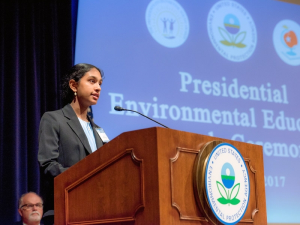 Shreya Ramachandran speaking at the podium