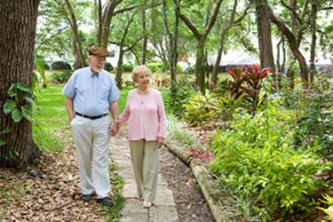 Photo of an older couple walking outside