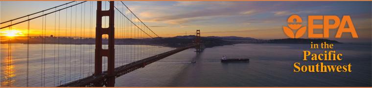 Golden Gate Bridge at sunrise with a ship passing beneath