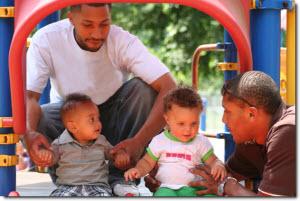 Dads with kids on playground