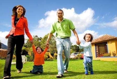 Image of a family outside a house