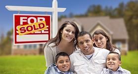 family in front of a newly purchased home