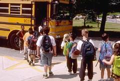 school children walking to the bus