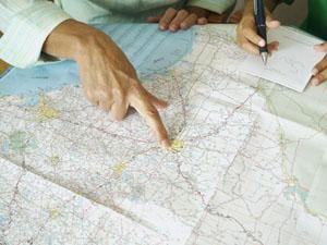Person pointing to map on a table