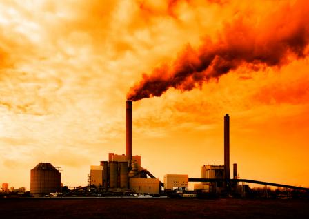 industrial facility with billowing smoke stack