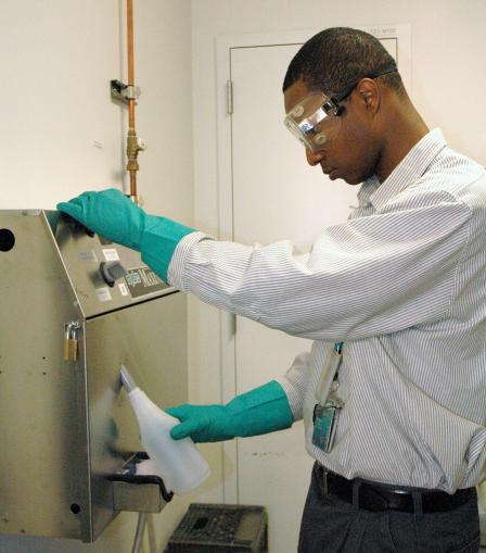 Green Clean Dispensor in use by employee