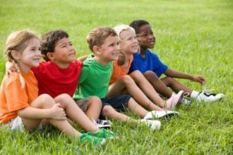 children sitting on the grass