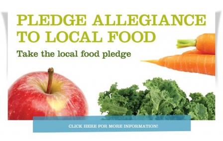 This Green Umbrella initiative picture says: Pledge Allegiance to Local Food- Take the local food pledge. It also features an apple, lettuce and carrots in the picture.