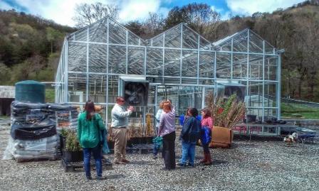 Tribal staff person talking with Region 4 staff about the greenhouse built to grow native species for use in environmental projects and for their cultural significance