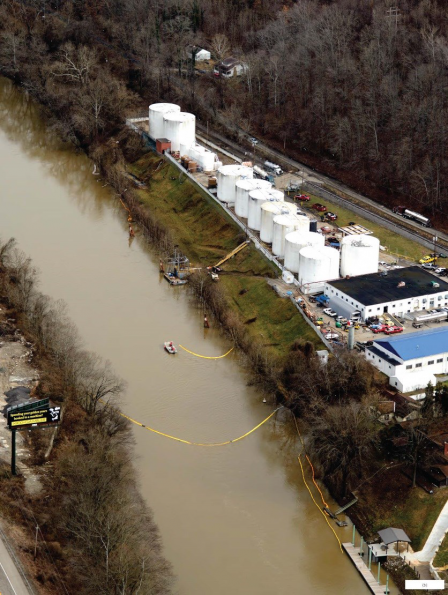 Aerial photo showing equipment used to contain spill in river