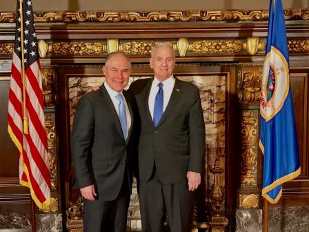 Administrator Pruitt standing beside the Minnesota Governor Mark Dayton in front of flags and an ornate fireplace