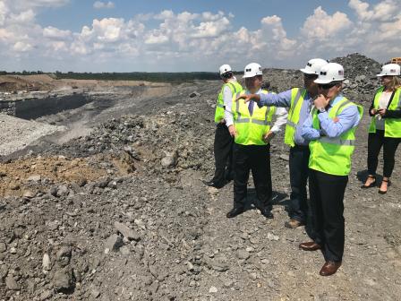 EPA Administrator Scott Pruitt, in hard hat is shown mining site at Liberty Mine by four people.  All wearing yellow safety vests and hard hats.