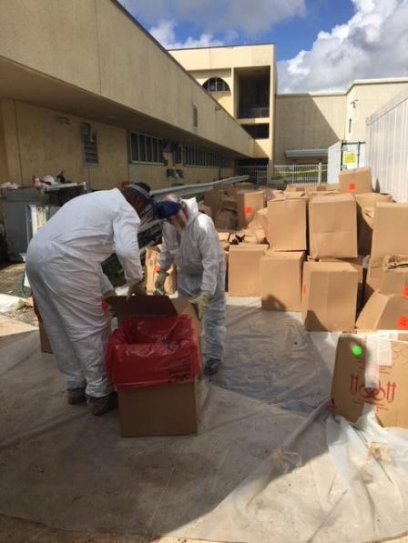 Men preparing medical waste for disposal at Juan F. Luis Hospital.