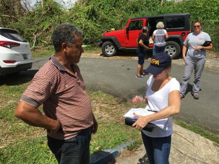 EPA field staff speaks with a citizen with others in the background