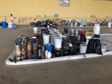 interior of a large warehouse with massive piles of cans and buckets