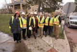 Administrator Pruitt and GCWW members in protective gear stand in front of a house