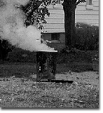 photo: burn barrel beside house