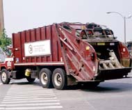 Garbage truck hauling municipal solid waste to a landfill