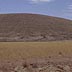 Desert grasslands near eroding butte
