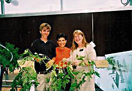 Youth/Education Category - 1st Place: Jake Jacobssen and instructor Karon Bishop sell their first tomato plants to librarian Leslie Lomers. The tomato plants were grown in aquaponic systems designed and constructed by students. Wastewater from the tilapia tanks was filtered through the system and fertilized the tomato plants.