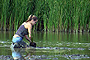 Civic/Nonprofit Organization - 1st Place: Armand Bayou -  Volunteer Erin McNabb of Houston plants California bulrush as part of the Intertidal Marsh Restoration project at Armand Bayou Coastal Preserve project near Houston. The goal of the Community-Based Habitat Restoration project was to spread populations of the plant into open-water areas of the bayou.