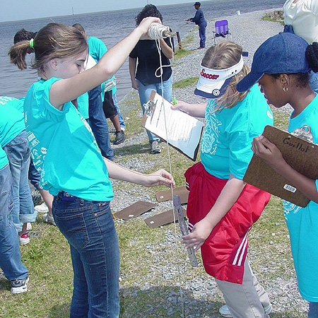 Youth/Education Category - 1st Place: A seventh grade student teaches 6th grade students how to use a sechi disk to measure turbidity. Hurst seventh graders guide over 600 younger students on wetland trips each year.