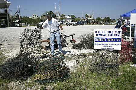 Government Category - 2nd Place: Gulf Coast Research Laboratory employee helping dispose of derelict crab traps at Bayou Caddy, Mississippi.
