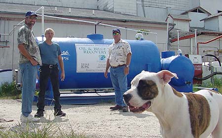 From left to right: Jim Needham of TAMU-CC, Duane Howell of Gulf
King Services, Jud Hall of Odessa Pump, and Harley the dog from Gulf King
Services checking the installation of the first Oil and Oily Bilgewater
Recovery Unit.  This is a split system with only the tanks mounted on the
main skid.