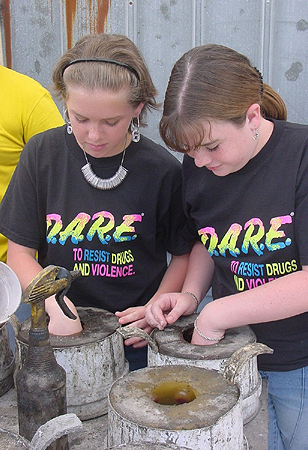 Two students from the Boys & Girls Club of Manatee County's Science is Cool
            After School Program build mini reef balls.
