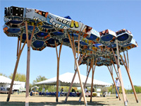 Photo of an arid zone shade structure raised on stilts and made of re-purposed political campaign signs. Honorable Mention in the Lifecycle Building Challenge Student Building Category.