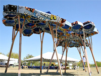 Photo of an arid zone shade structure raised on stilts and made of re-purposed political campaign signs.  Honorable Mention in the Lifecycle Building Challenge Student Building Category.