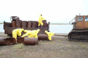 residents load drums to be removed
