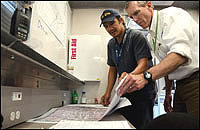 Brooks gets an update from EPA On-Scene Coordinator John Frey in Region 7's mobile command post in Joplin