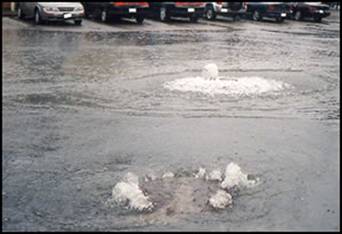 Overflowing manhole in Rhode Island parking lot
