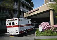 Picture of ambulance parked outside emergency entrance of hospital