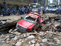 Image of car in a sinkhole on a damaged street