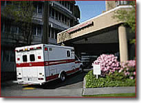 Photo of a hospital entrance and ambulance.
