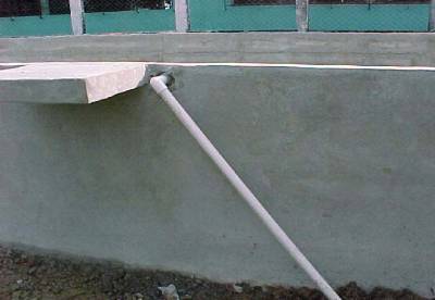 The photo shows a small diameter pvc pipe entering through the outside wall of a sand filter.