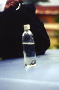The photo shows a plastic bottle with clear water inside of it.